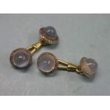 A pair of yellow metal and moonstone cuff-links, radially set with diamond chips