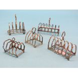 Five various silver toast racks, approx. 17.5oz. total
