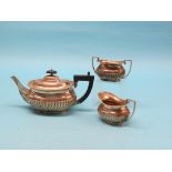 An Edward VII silver half-fluted teapot, Birmingham 1906, and a near-matching sugar bowl and milk