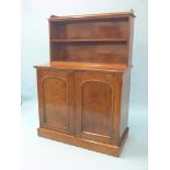 An early Victorian mahogany chiffonier, two open shelves above panelled cupboard base with two