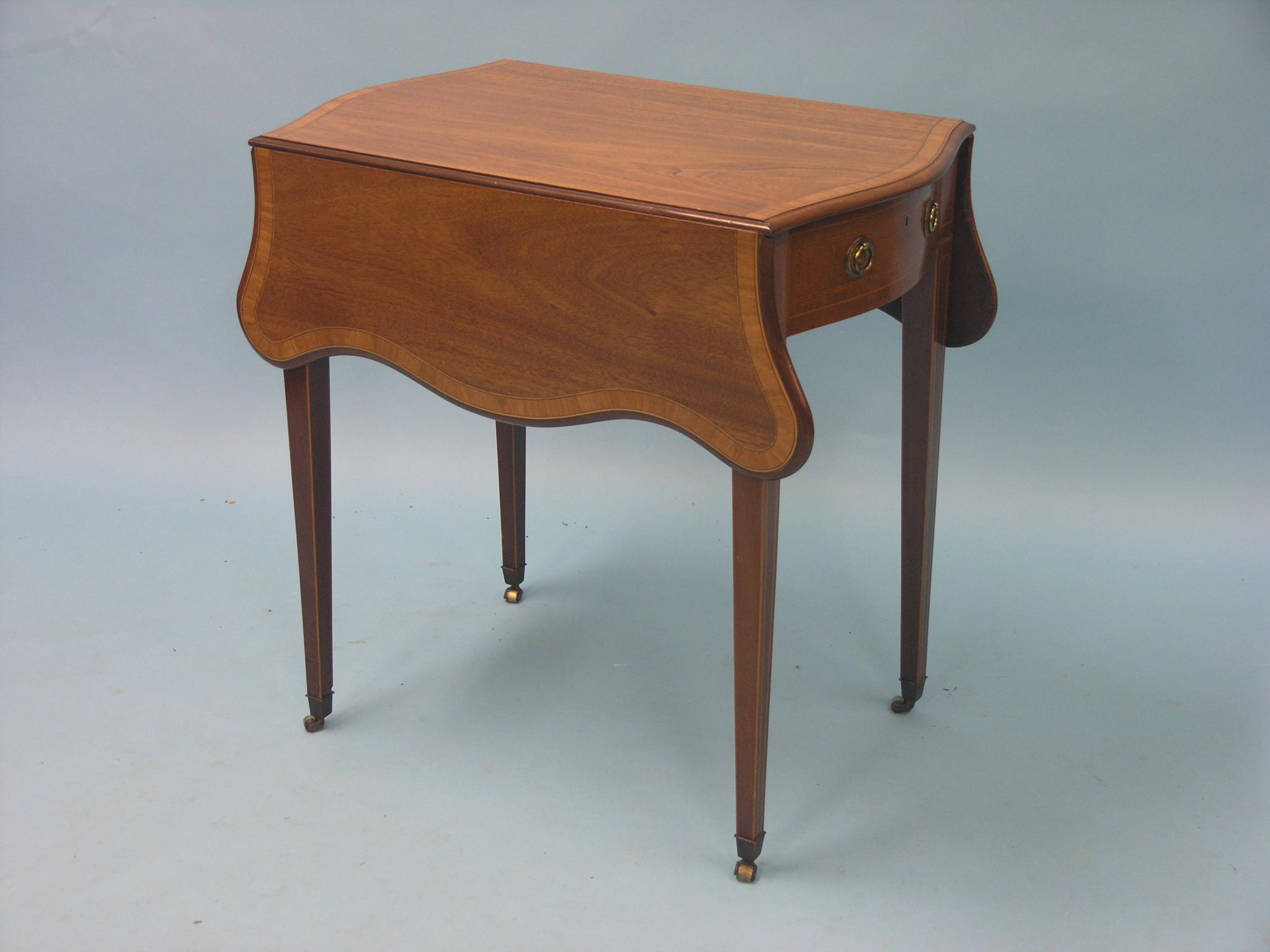 A small Hepplewhite-style mahogany Pembroke table, serpentine-shape with single frieze drawer,