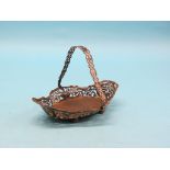 An Edward VII silver cake basket, lobed oval shape with pierced detail and swing handle, William