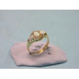 An Edwardian lady's 18ct. gold ring, set three opals and diamond chips, claw settings, size N,