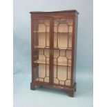 A 19th century mahogany bookcase, (modified) pair of full-length astragal-glazed doors enclosing