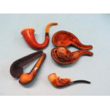 Two carved meerschaum pipes, one with silver mount, and two other meerschaum pipes