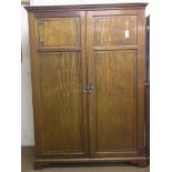 An early 20th century mahogany wardrobe, enclosed by a pair of full-length panelled doors, 4ft.