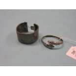 A Victorian white metal bangle, and an engraved white metal bangle