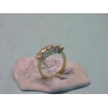 An 18ct. gold and diamond half-hoop ring, five claw-set diamonds size I