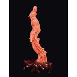 A carved coral figure of Guanyin with flute, China, early 20th century gr 200 circa, h cm 20