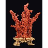 A finely carved coral group of three Guanyin between roses with carved ivory base, China, early 20th
