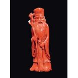A carved coral wise man with stick and scroll, China, early 20th century  gr 288, h cm 13,5 Starting
