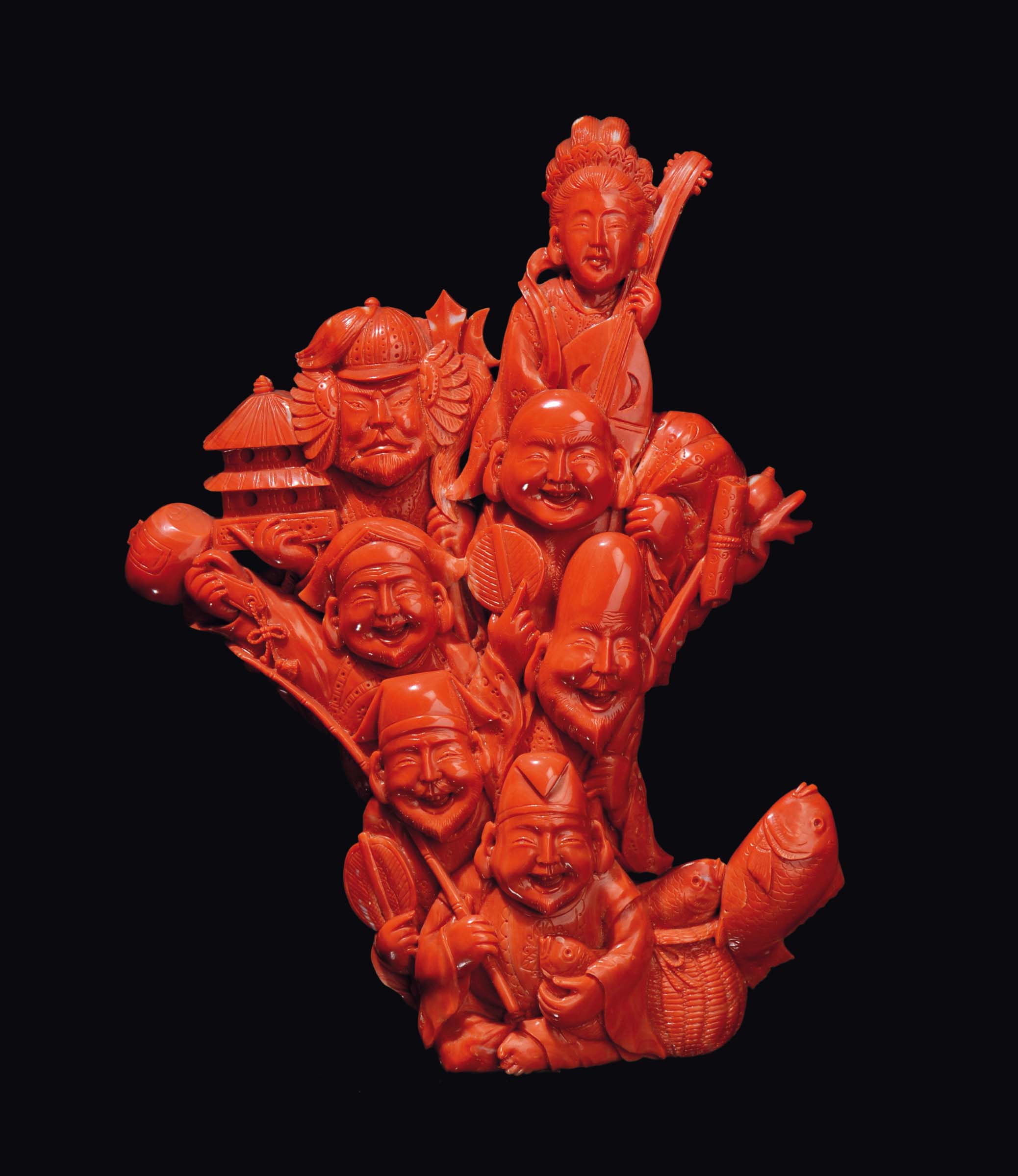 A carved coral group of dignitaries and fishermen with a basket full of fish, China, early 20th