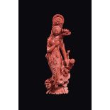 A carved coral "Guanyin and child with lotus flowers", China, Qing Dynasty, lete 19th century gr