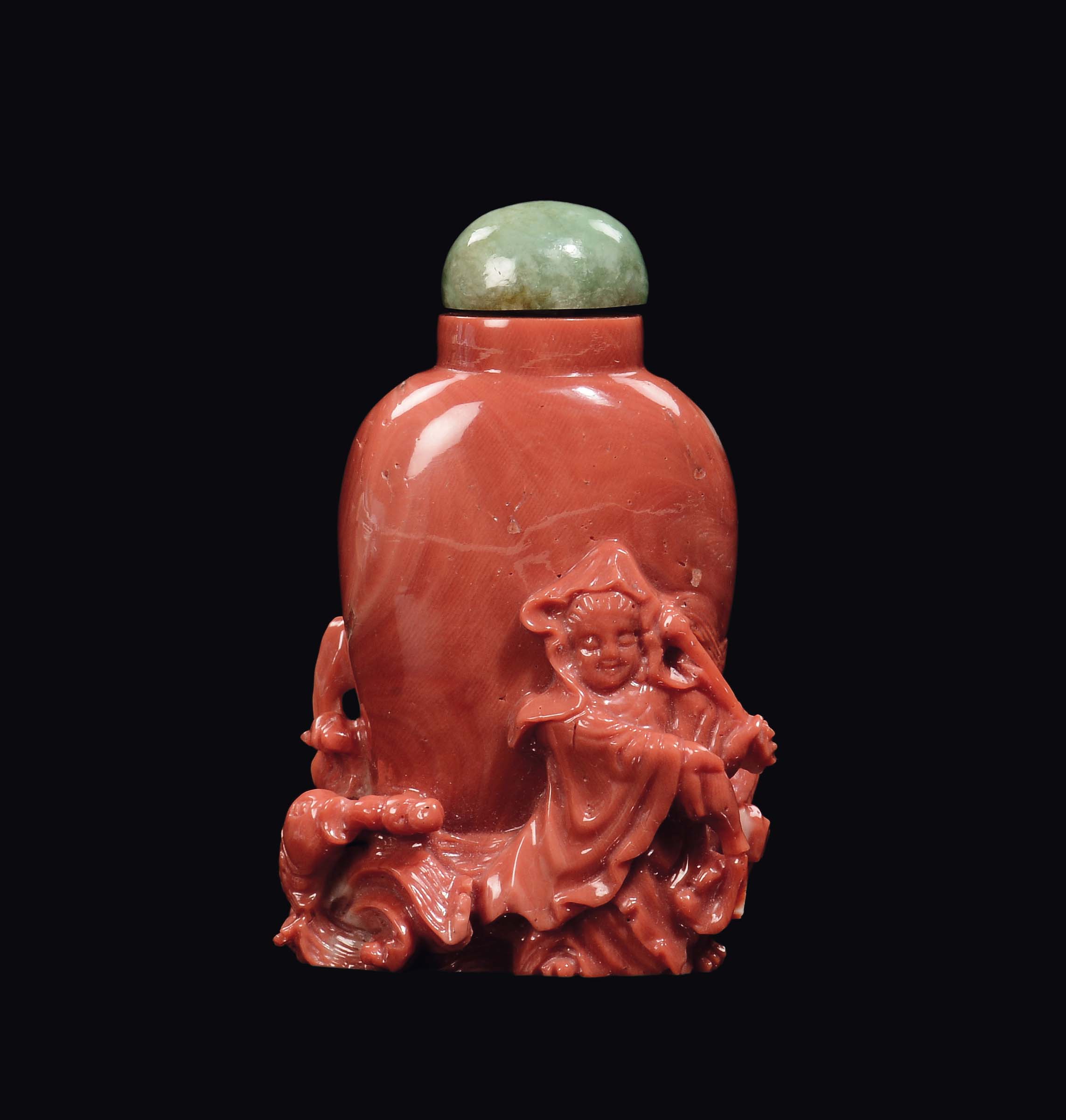 A carved coral snuff bottle with Guanyin and fish in relief, China, Qing Dynasty, late 19th