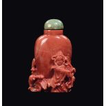 A carved coral snuff bottle with Guanyin and fish in relief, China, Qing Dynasty, late 19th