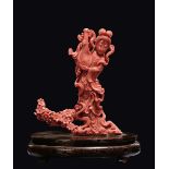 A carved coral "playing Guanyin on a flowering branch", China, early 20th century gr. 499 con