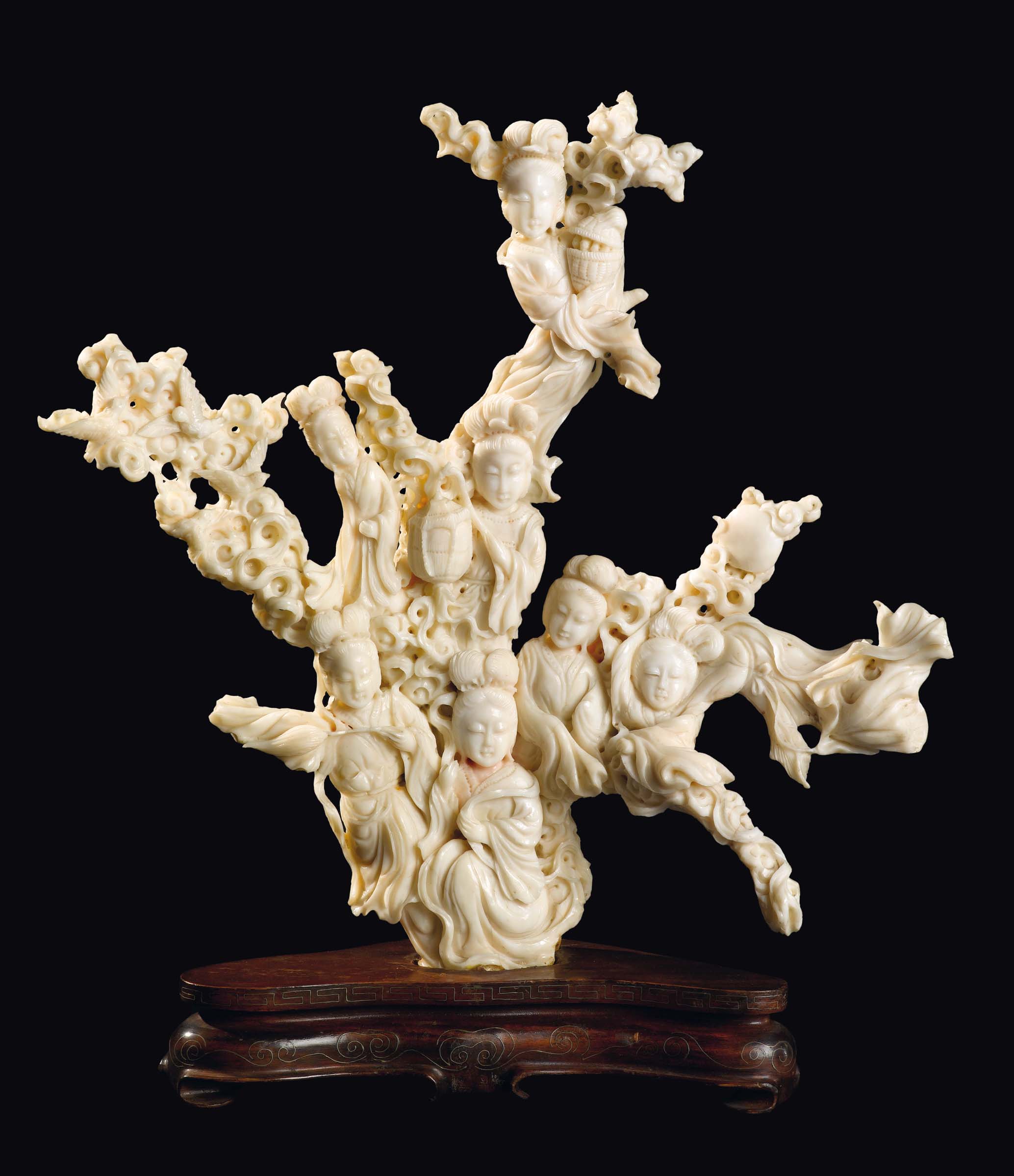 A large carved white coral "seven Guanyin with vases and birds" group, China, early 20th century gr.