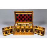 A late Victorian oak cased games compendium, the front opening to reveal boxwood and ebony chess