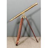 A brass telescope of 19th Century design, 38ins long, with stained wood and brass mounted tripod