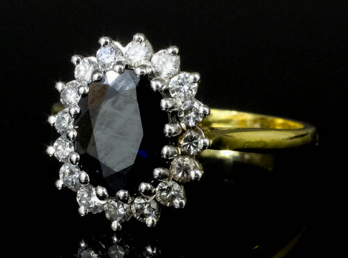 A modern 18ct gold mounted sapphire and diamond dress ring, the oval cut sapphire approximately - Image 2 of 2