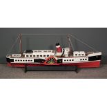 A scratch built painted wood model of a paddle steamer, 43ins long, with ebonised wood stand for