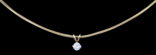 A modern 9ct gold mounted diamond pendant, the brilliant cut stone approximately .33ct, on 9ct