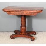 A late Georgian mahogany rectangular card table, the baize lined folding top with rounded edge, on