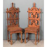 A pair of Victorian cast iron high back garden chairs of "Coalbrookdale" design, each 52.5ins