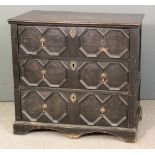 A stained wood chest of drawers of 18th Century design, fitted three drawers with moulded fronts and