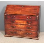 A George III mahogany bureau, the leather lined slope enclosing cupboard, twelve small drawers and