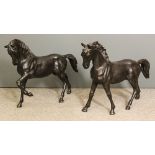Two 20th Century dark brown patinated bronze figures of horses, each 23ins high