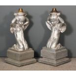 A pair of silver painted metal cherub pattern electric lamp bases, each 30.5ins high