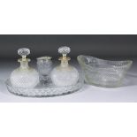 A pair of Victorian diamond cut and slice cut glass spherical scent bottles, the shoulders decorated