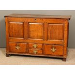 An 18th Century panelled oak mule chest with plain top, the front with three fielded panels and