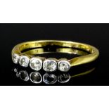 A Victorian 18ct gold and platinum mounted five stone diamond ring, the old cut stones each