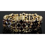 A late Victorian gold coloured metal mounted all garnet set bracelet, the eight diamond pattern