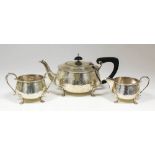 A George V and George VI hammered silver Harlequin three piece tea service of circular squat form,