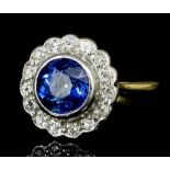 A modern 18ct gold and platinum mounted sapphire and diamond ring, the circular cut Ceylon