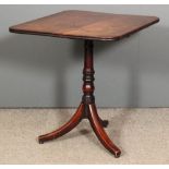 A late Georgian mahogany rectangular tripod table, the plain one piece top with reeded edge, on