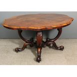 An early Victorian rosewood oval breakfast table, the top of shaped outline and with moulded edge,