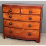 A late Georgian mahogany bow-front chest of drawers fitted two short and three long drawers, on