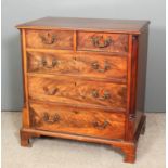 A George III mahogany chest of drawers with crossbanded top fitted two short and three long drawers,