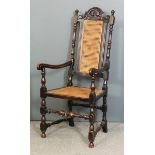 A late Victorian ebonised beechwood open armchair of Carolean design with pierced and shaped crest