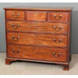 A George III mahogany chest of drawers, the top with moulded edge, fitted three short and three long