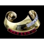 A 1950s gold coloured metal mounted ruby and diamond set dress clip, the scrolling face set to one