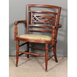 A late Victorian walnut armchair, the square curved back with pierced splats, the oval seat