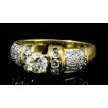 A modern 18k gold mounted all diamond set dress ring, the central brilliant cut diamond