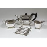 A George VI silver three piece tea service of octagonal panelled form, on paw pattern feet,