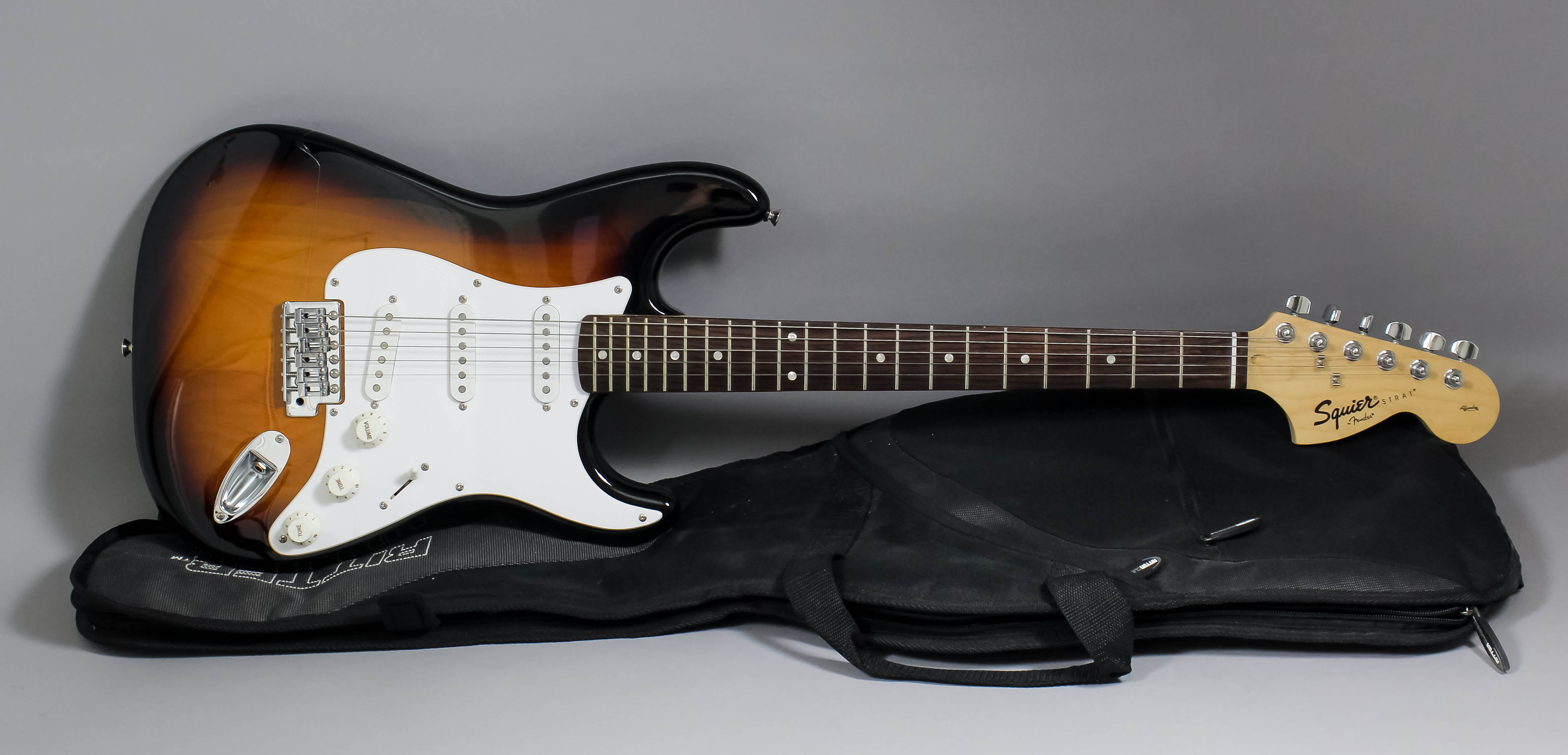 A modern Fender "Squier Strat" electric guitar, 39ins long, with case for same Note : This is