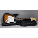 A modern Fender "Squier Strat" electric guitar, 39ins long, with case for same Note : This is